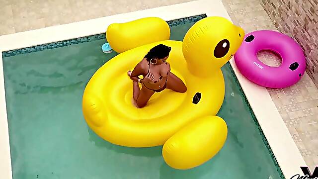 Maxine X, the sexy MILF, lounges in a pool showing off her big natural