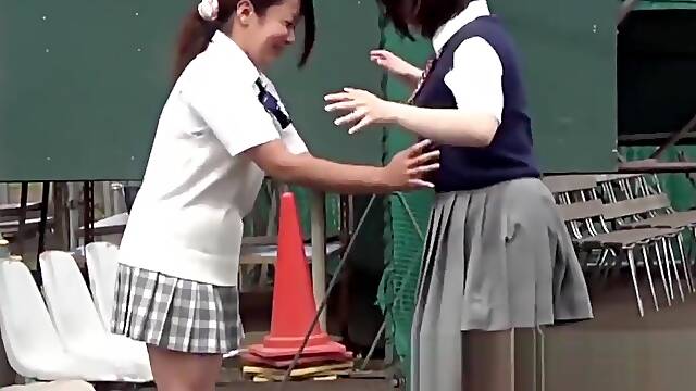 Naughty Japanese schoolgirls pissing in secret public place